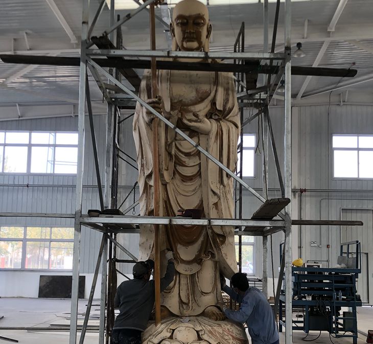 scrape the putty on  bronze buddha sculptures