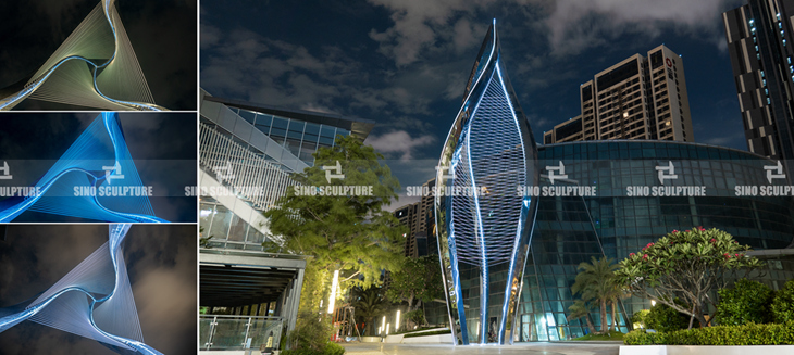 Night view of stainless steel spiral sculpture