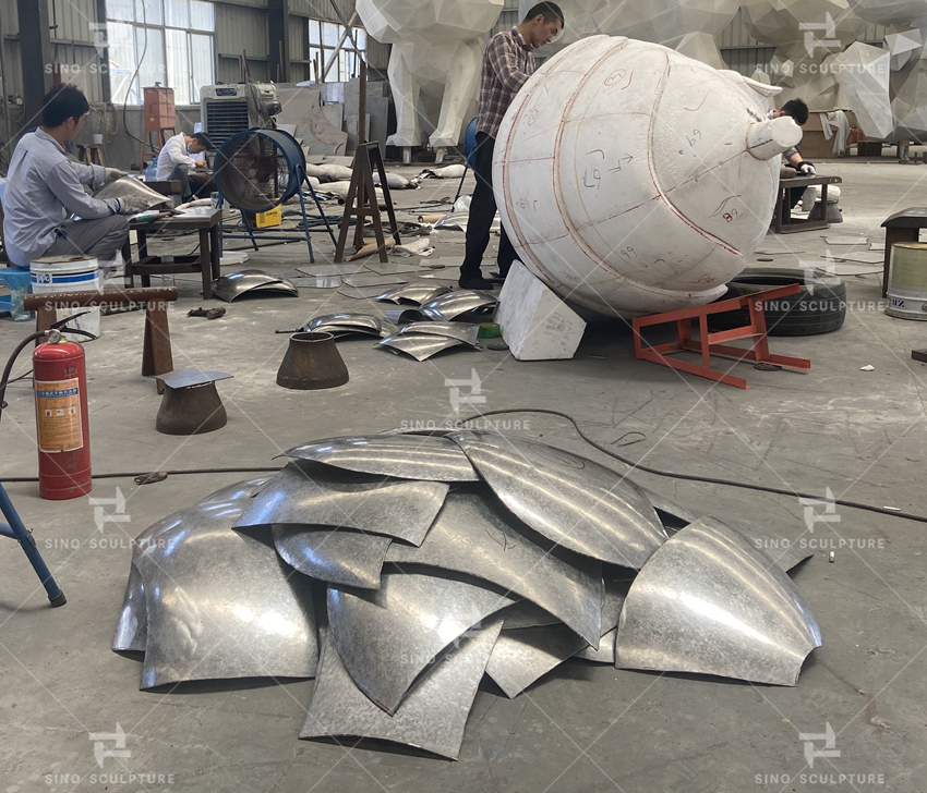 Stainless steel panels are being forged by hand craft in Sino Sculpture Tianjin Factory.