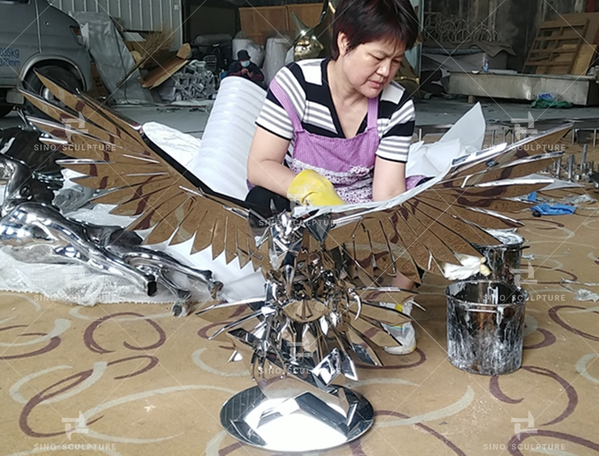 Mirror polish the stainless steel Falcon sculpture before gold plating..png
